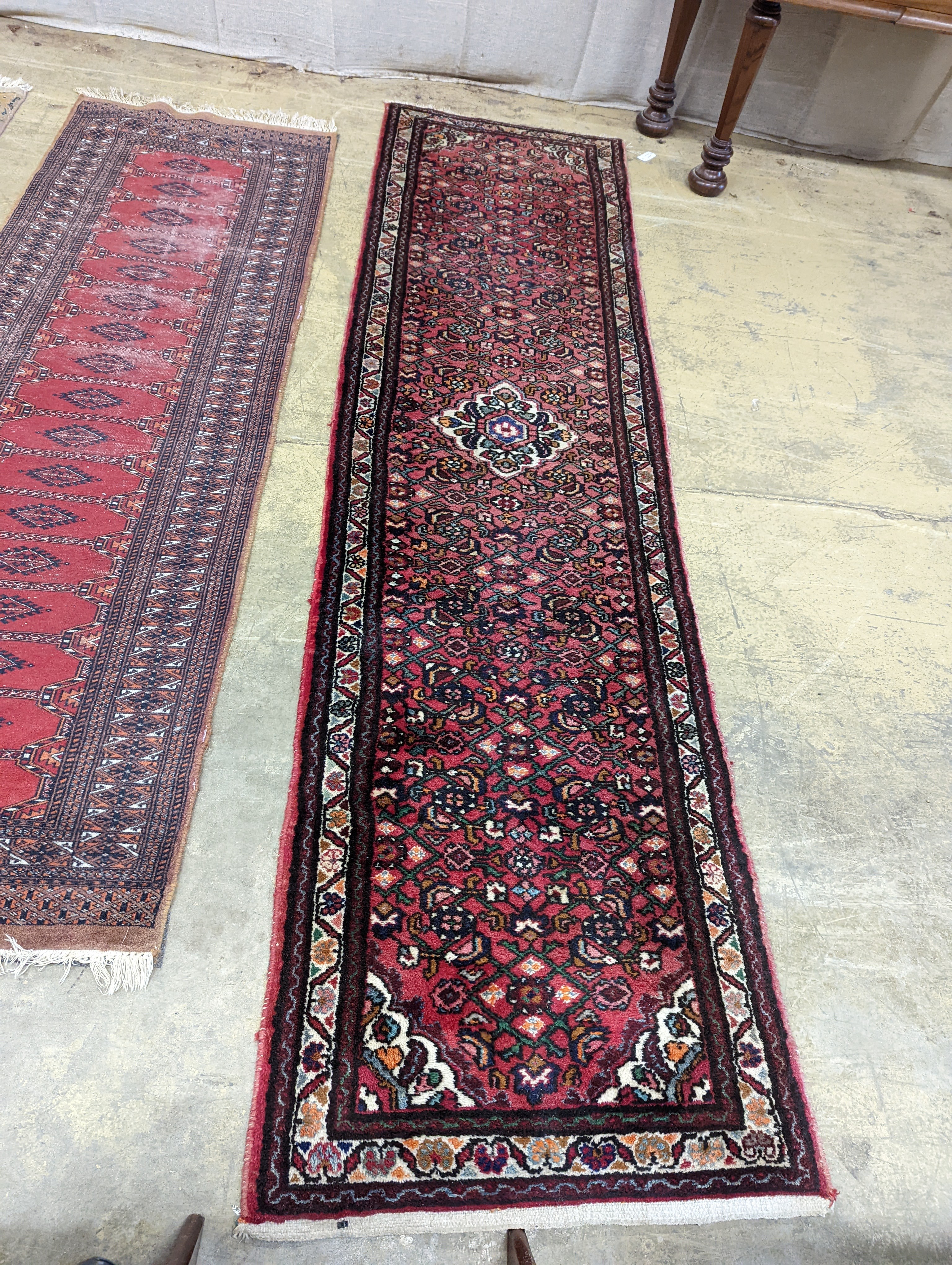 A North West Persian red ground runner and a Bokhara runner, larger approx. 290 x 78cm